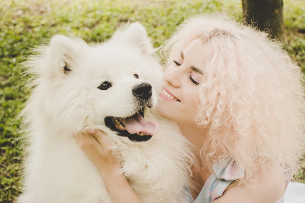Woman with white, furry dog